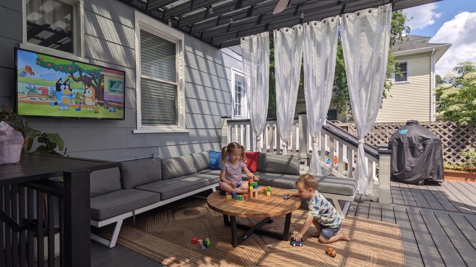 Kids playing on a covered deck lounge