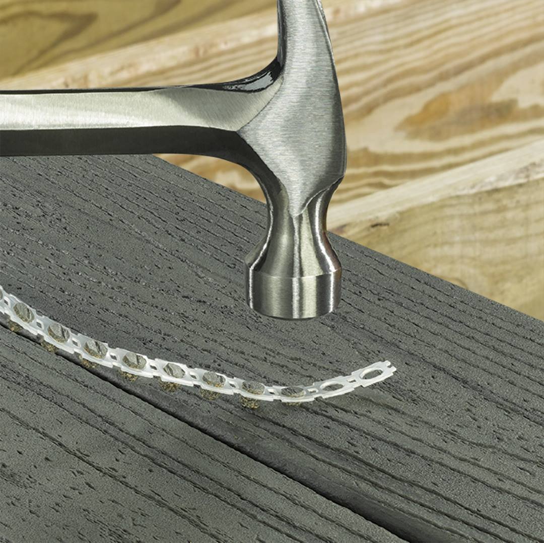 Collated Cortex plug strip being set into a composite deck board with a hammer