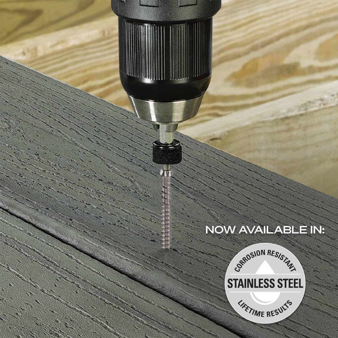 Stainless steel Cortex screw being driven through a composite deck board's edge with the guide bit