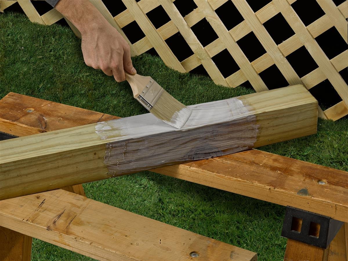 FastenMaster Ground Contact Coating being applied to a deck post