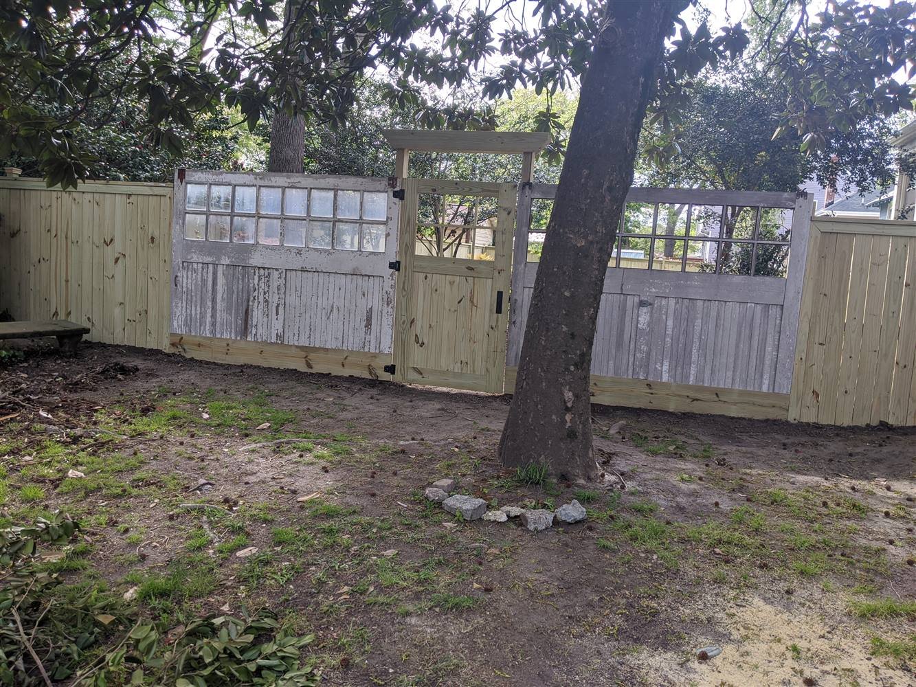 Reclaimed garage doors built into a custom fence gate in Colonial Place, Norfolk, VA.